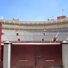 Las gradas vacías del **museo de las ventas**, con sus banderas españolas, esperan la próxima corrida.