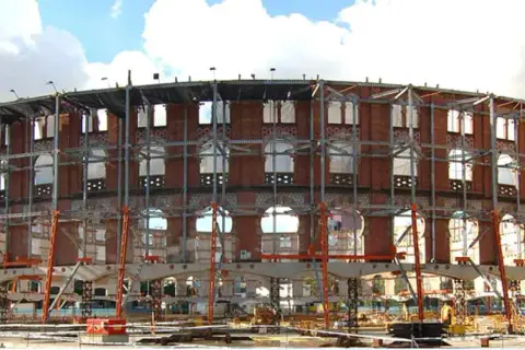 La antigua plaza de toros de la plaza España de Barcelona, ahora en proceso de reforma, luce una estructura metálica exterior.